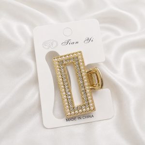 Pinza metal perla y strass dorada